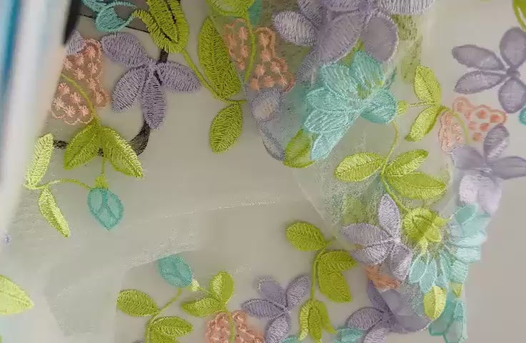Detalle de encaje exquisito multicolor tonos pastel con doble borde decorativo
